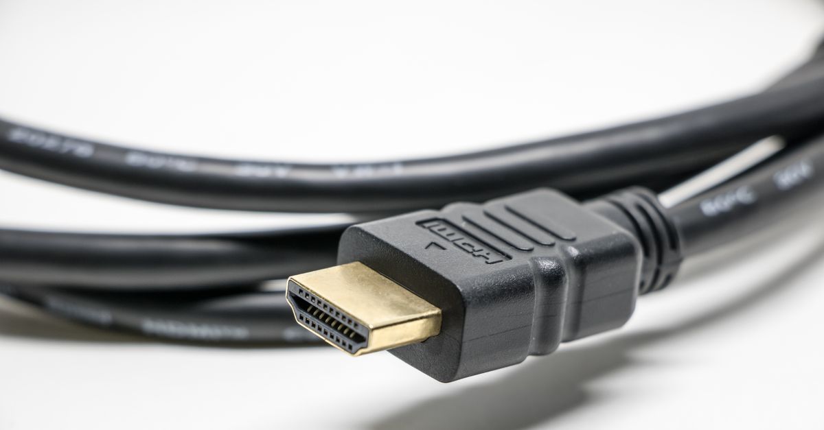 A detailed image of a black HDMI cable with gold connectors on a white background.